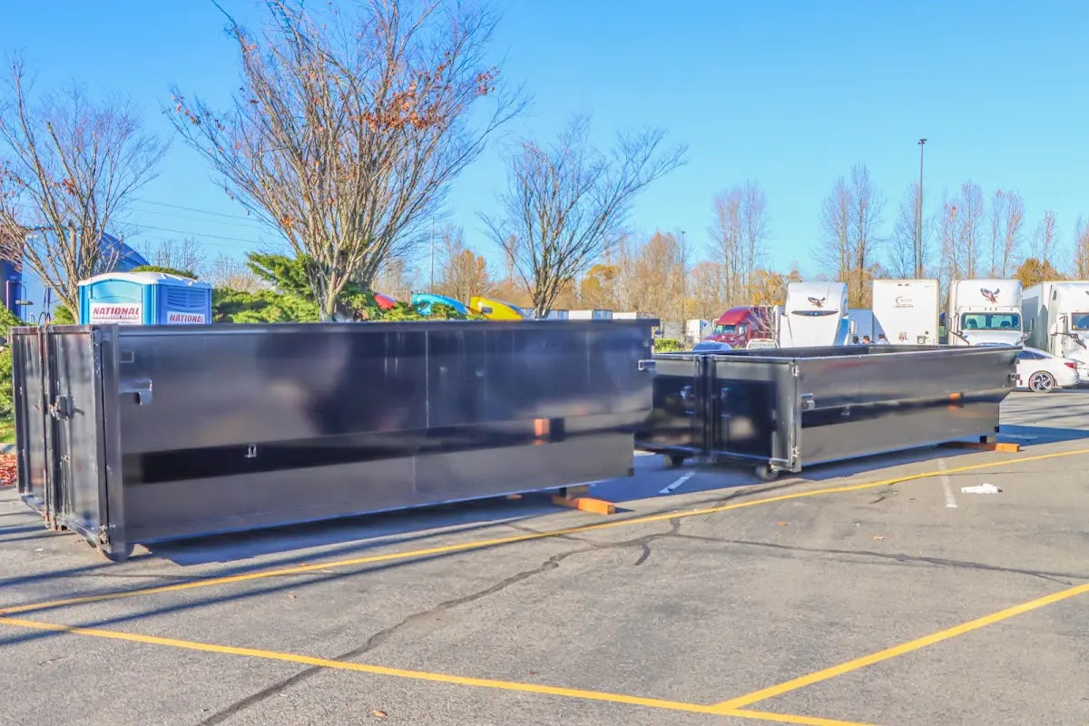 Professional dumpster rental service with roll-off container on residential driveway in Cheval